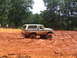 1995 Ford C-350 (Centurion Conversions) - Ford Bronco struggling in thick mud during an off-road event.
