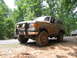 1995 Ford C-350 (Centurion Conversions) - This 1992 Ford Bronco is covered in mud and equipped with off-road tires.