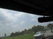 1995 Ford C-350 (Centurion Conversions) - A white SUV is visible from the interior of another vehicle, with a cloudy sky overhead.