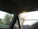 1995 Ford C-350 (Centurion Conversions) - View from the passenger side of a vehicle, looking out the window at trees and a body of water.