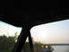 1995 Ford C-350 (Centurion Conversions) - Looking out from the interior of a vehicle towards a lake at sunset.