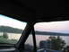 1995 Ford C-350 (Centurion Conversions) - Driving by a lake at sunset, looking out the passenger side window.
