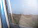 1995 Ford C-350 (Centurion Conversions) - A blurry reflection of a person is seen in a vehicle's window, obscuring the outside landscape.
