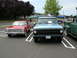 1968 Ford F-100 - Three vehicles parked in a lot: a red car, a blue 1967 Ford F-100, and a green pickup truck.