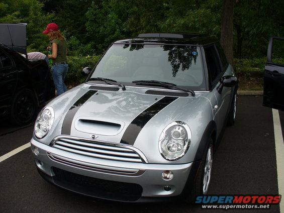 Silver Mini Cooper with black racing stripes, front 3/4 view