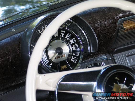 Interior dashboard with white steering wheel and speedometer showing 40523 miles