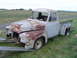 1955 Ford F-100 - A weathered and rusty 1953 Ford F-100 pickup truck is being transported on a trailer.