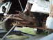 1955 Ford F-100 - Front suspension and frame of a 1955 Ford F-100, showing significant rust damage.