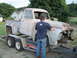 1955 Ford F-100 - A weathered 1955 Ford F-100 truck is loaded onto a U-Haul trailer, awaiting restoration.