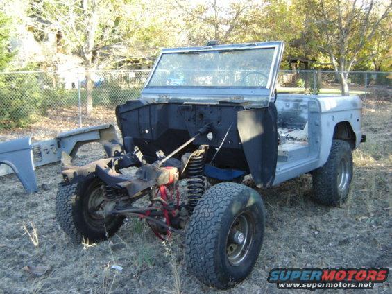 1971 Ford Bronco body stripped down, parked outdoors on dry grass