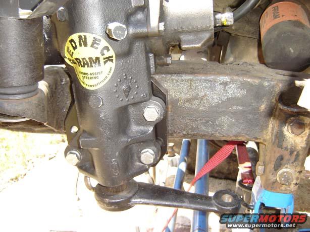 close-up of steering box with yellow sticker that says 'ONE-CK RAM HYDRO-ASSIST STEERING'
