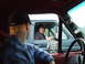 1990 Ford Bronco - Two individuals in separate vehicles make eye contact through their windows, capturing a moment of connection on the road.