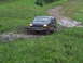 1990 Ford Bronco - This 1990 Ford Bronco is navigating a muddy trail, kicking up water as it goes.