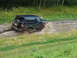 1990 Ford Bronco - 1990 Ford Bronco navigating a challenging muddy terrain.