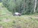 1990 Ford Bronco - Two vehicles on a dirt road in a forest, one is a 1990 Ford Bronco.
