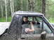 1990 Ford Bronco - Man and child inside a very muddy off-road vehicle, driving through a wooded area.