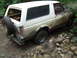 1990 Ford Bronco - This Ford Bronco appears to be from the late 1980s or early 1990s, not a 1990 model, as it navigates a challenging off-road terrain.