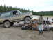 1990 Ford Bronco - A 1990 Ford Bronco is driven onto a destroyed sedan in a junkyard scene.