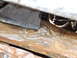 1990 Ford Bronco - Close-up view of the heavily rusted undercarriage and suspension parts of a vehicle.