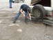1990 Ford Bronco - A person is digging with a shovel to free a vehicle stuck in the mud.