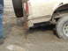 1990 Ford Bronco - Vehicle stuck in mud with a hi-lift jack being used for extraction.