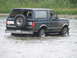 1990 Ford Bronco - 1990 Ford Bronco navigating a water crossing with its spare tire mounted externally.