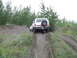 1990 Ford Bronco - White 1990 Ford Bronco navigating a challenging dirt incline off-road.