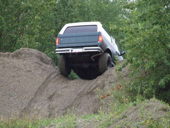 1990 Ford Bronco rear view climbing dirt hill