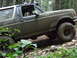 1990 Ford Bronco - This 1990 Ford Bronco navigates a challenging off-road course covered in mud.