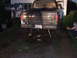 1990 Ford Bronco - Rear view of a black pickup truck, possibly a Ford Bronco, with its license plate visible and supported by wooden blocks.