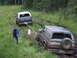1990 Ford Bronco - Two Ford Broncos navigate a muddy trail, with one vehicle assisting the other.