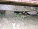 1990 Ford Bronco - The vehicle's frame and undercarriage are heavily coated in mud, suggesting it has been driven through difficult terrain.