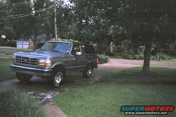 1995 Ford Bronco parked on driveway, front 3/4 view