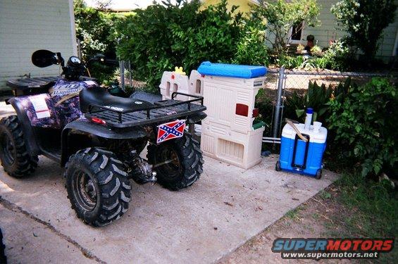 Purple camouflage ATV with Confederate flag license plate, rear view