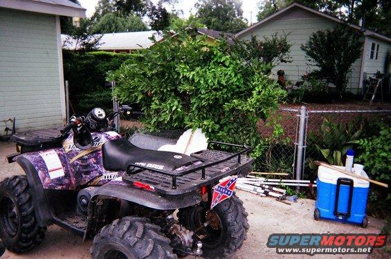 Purple camouflage ATV with a Confederate flag on the rear fender