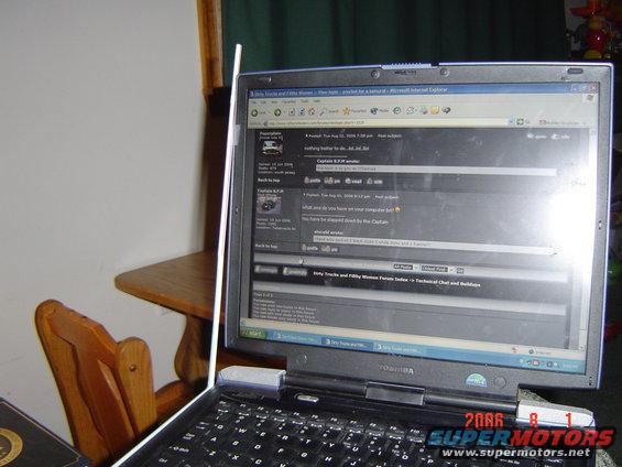 Laptop screen shows a forum thread with text and user avatars