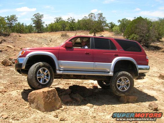 1996 Toyota 4Runner driving over rocks on a dirt trail