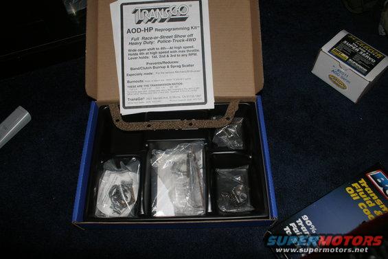 TransGo AOD-HP Reprogramming Kit box with gasket and parts inside, plus a Super Servo box