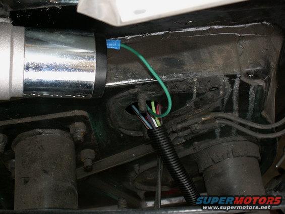 nice neat harness into engine bay inside tubing....no grommets in firewall yet...compressor for air horns to left of wiring