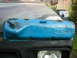 1979 Ford Bronco - A blue Ford valve cover is mounted on the hood of a vehicle, with the Ford emblem clearly visible.
