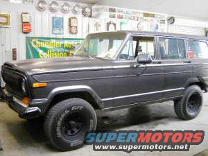 Dark 1977 Jeep Wagoneer, 3/4 front view. Visible 'Supermotors' logo