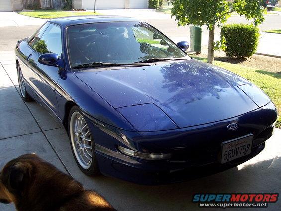 Blue 1995 Ford Probe with pop-up headlights and aftermarket wheels