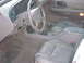 1994 Ford Taurus - The interior of a 1995 Ford Taurus, tan leather seats and a beige dashboard.