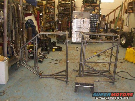 Custom roll cage frame sections in a workshop
