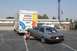 1994 Ford F-150 - A silver sedan is loaded onto a U-Haul trailer, with a U-Haul truck visible ahead.