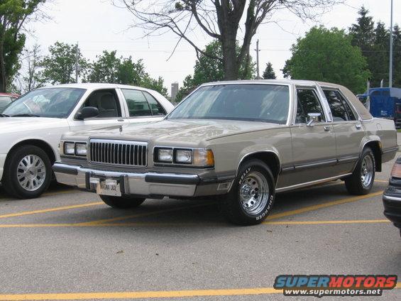 1988 Mercury Grand Marquis parked next to a white car