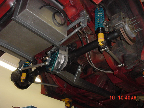 Rear axle assembly with aftermarket suspension and fuel tank