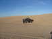 1985 Ford Ranger - A dark 1985 Ford Ranger is captured mid-air as it jumps over a sand dune.