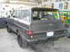 1977 Jeep Wagoneer - This Jeep Grand Wagoneer is parked indoors, showing its rear exterior and spare tire.