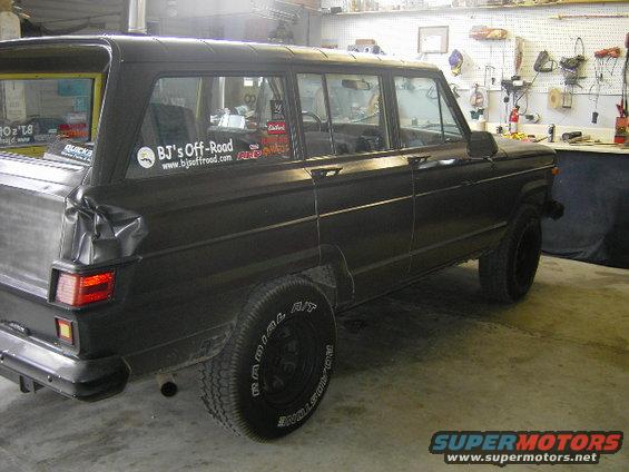 Black 1977 Jeep Wagoneer, rear quarter view, with BJ's Off-Road sticker